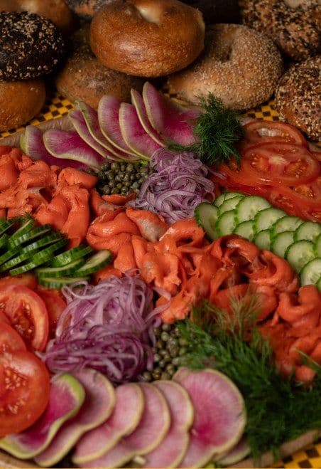 Smoked salmon platter with tomatoes, cucumbers, red onions, and dill